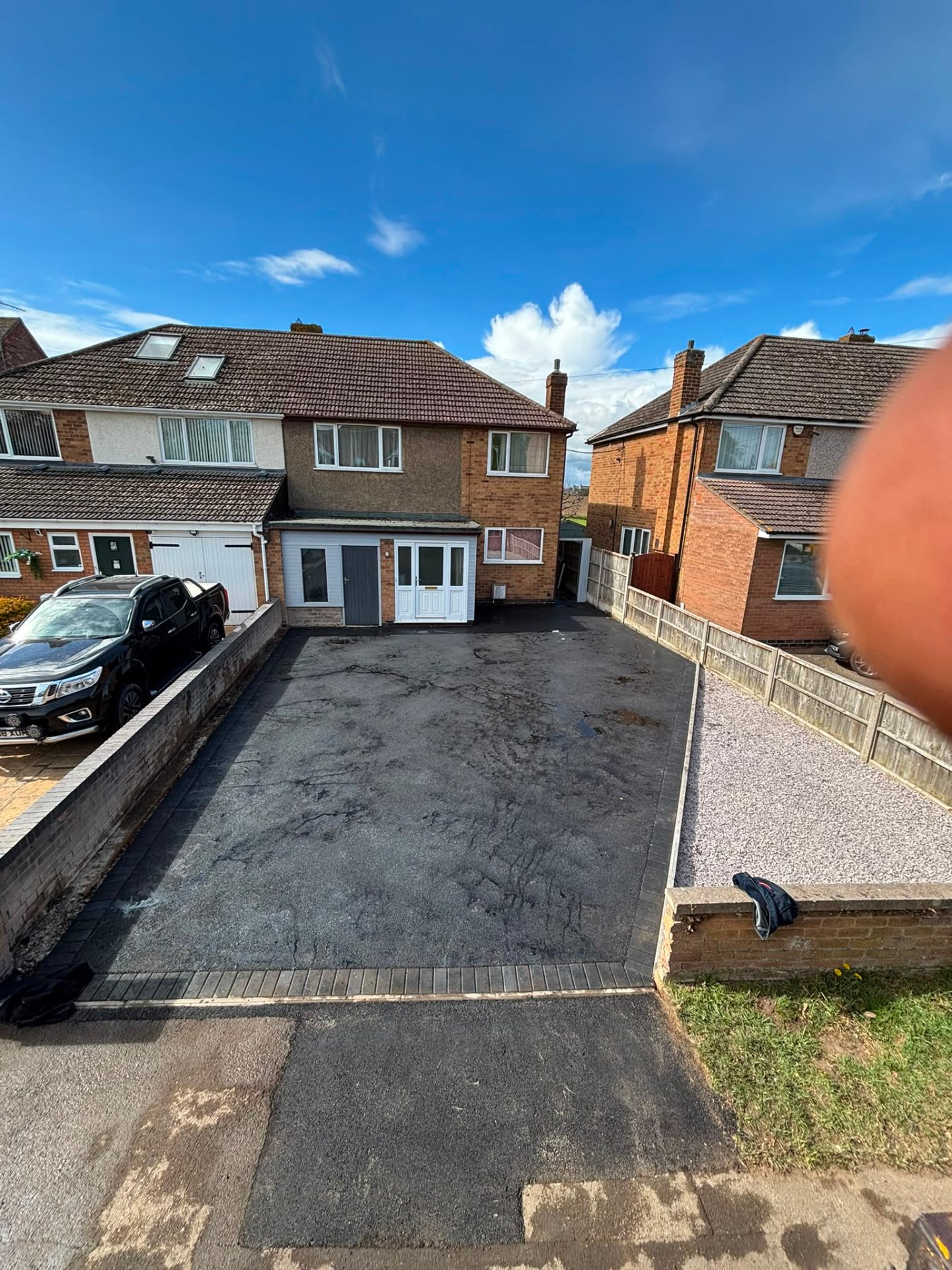 Fresh black tarmac driveway with clean rolled finish