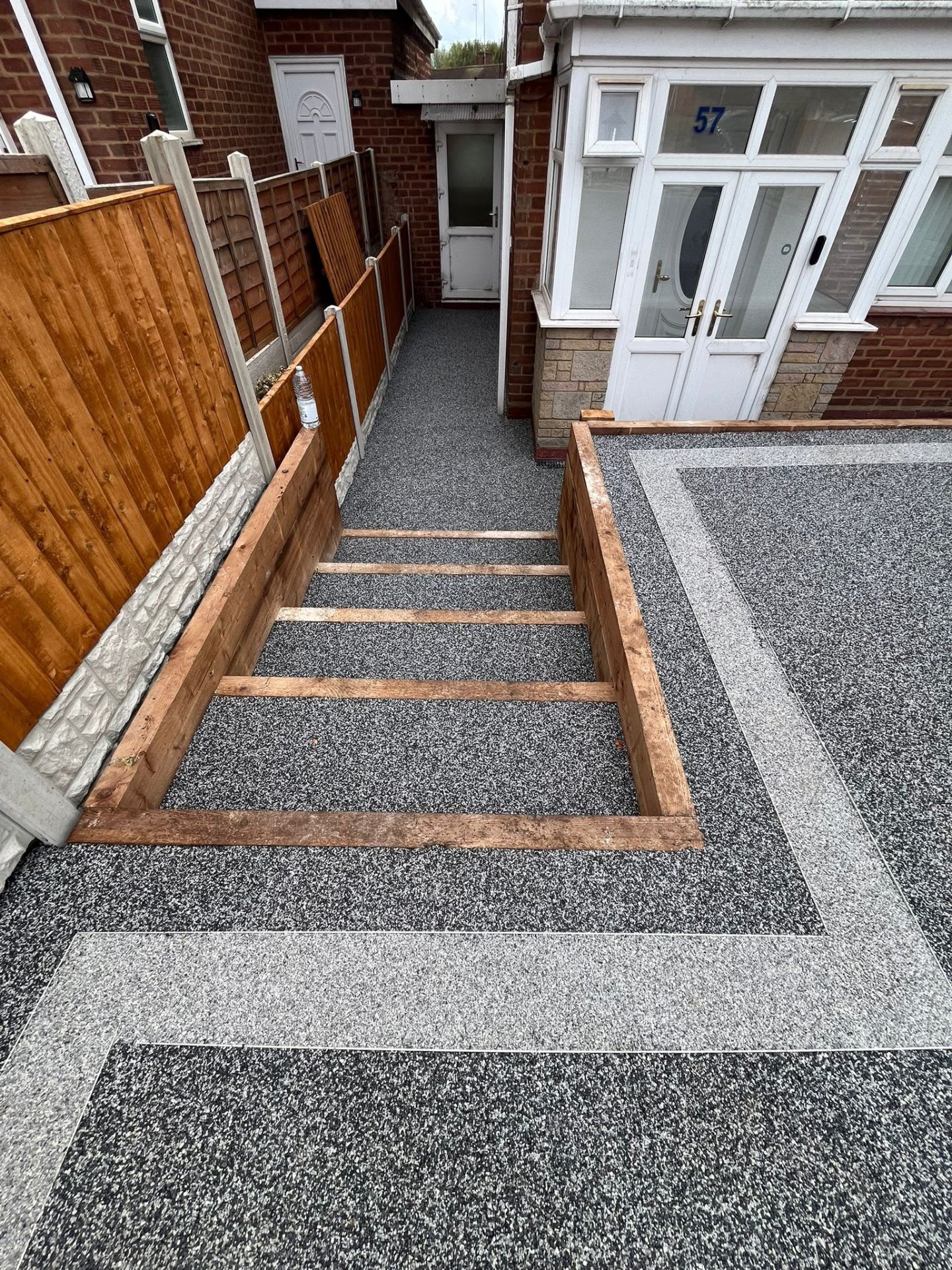 Premium resin bound driveway installed in Stourbridge with sleeper-framed step detail