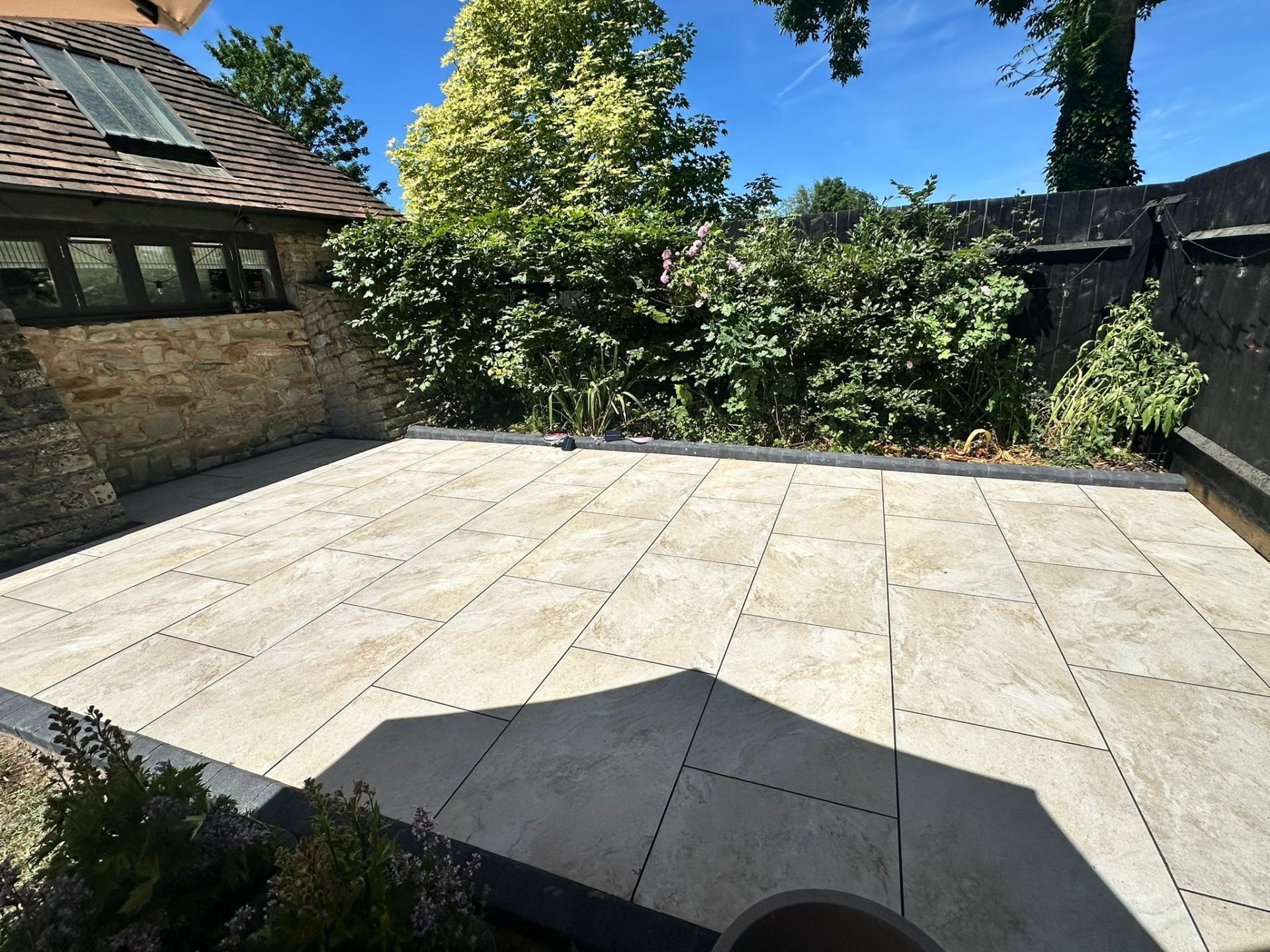 Stone-effect porcelain patio with feature step