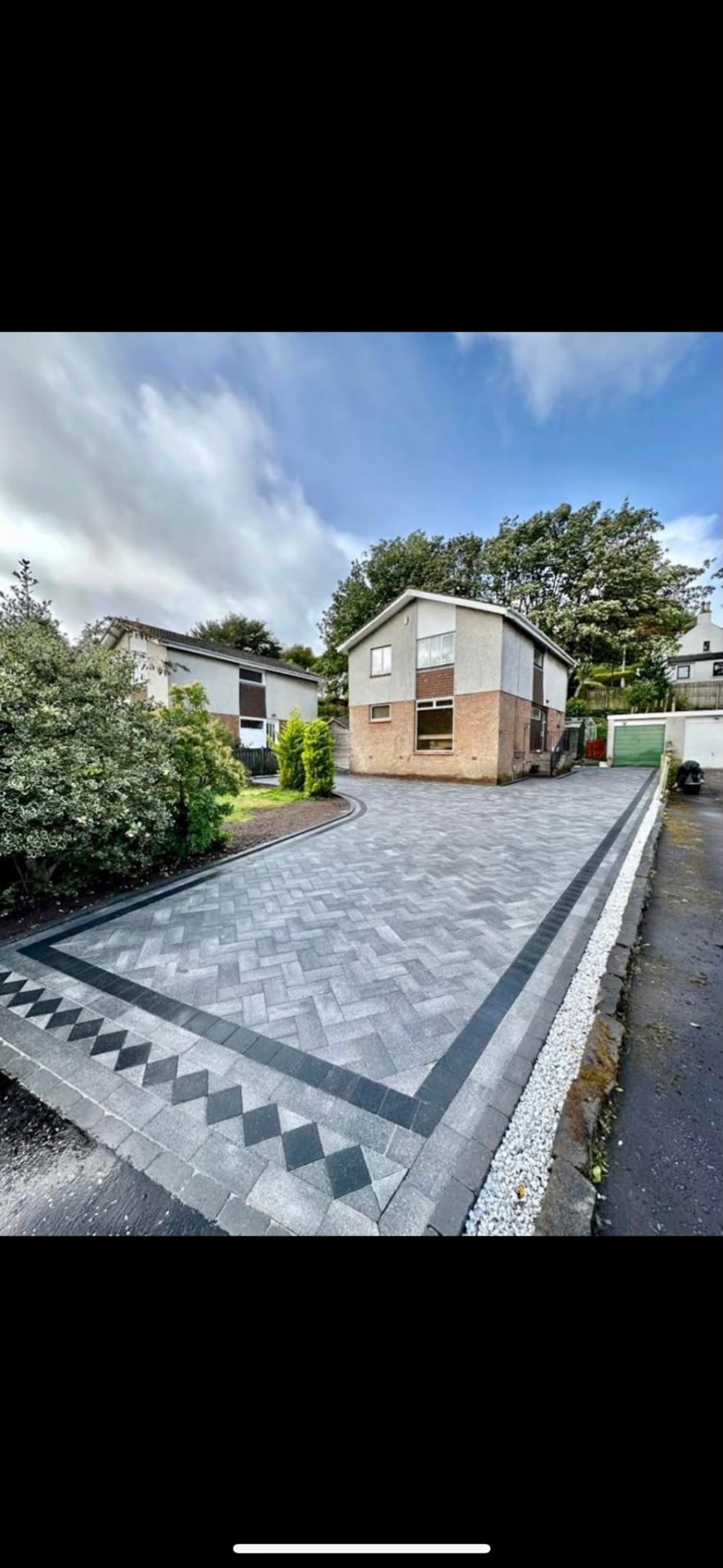 Grey herringbone block paving driveway with charcoal border